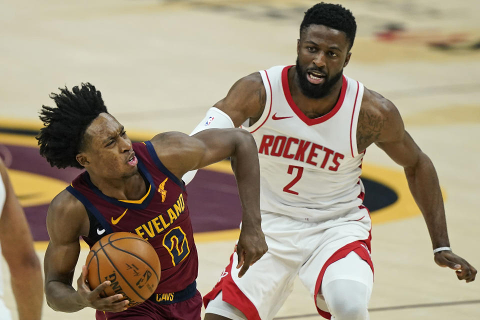 Cleveland Cavaliers' Collin Sexton, left, drives against Houston Rockets' David Nwaba in the first half of an NBA basketball game, Wednesday, Feb. 24, 2021, in Cleveland. (AP Photo/Tony Dejak)