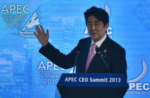 Japan's Prime Minister Shinzo Abe gives a speech during the Asia-Pacific Economic Cooperation summit on Bali on October 7, 2013