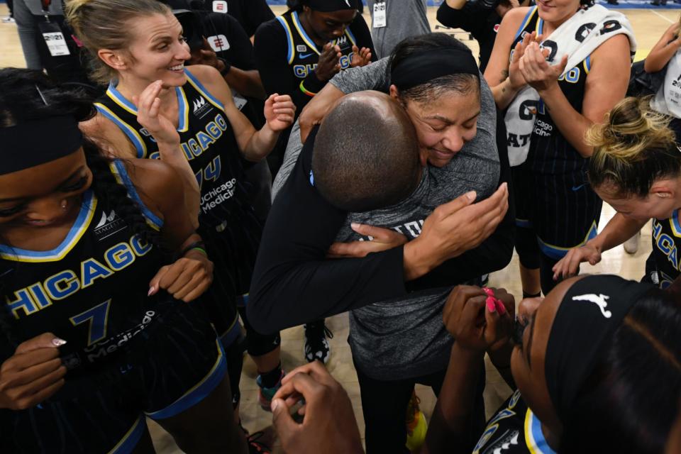 Candace Parker (center) hugs Sky coach James Wade as the team celebrates clinching a spot in the 2021 WNBA Finals.