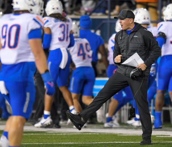 <p>Eli Lucero/The Herald Journal via AP)</p> Boise State interim head coach Spencer Danielson celebrates after a Utah State turnover in the first half of an NCAA college football game Saturday, Nov. 18, 2023, in Logan, Utah.