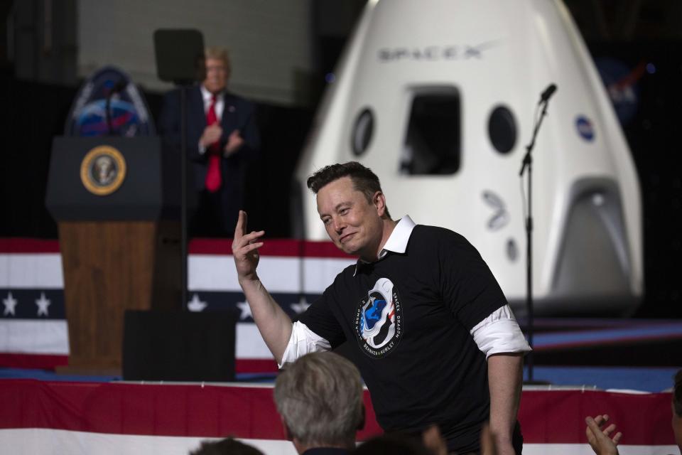 Elon Musk in front of a crowd of people