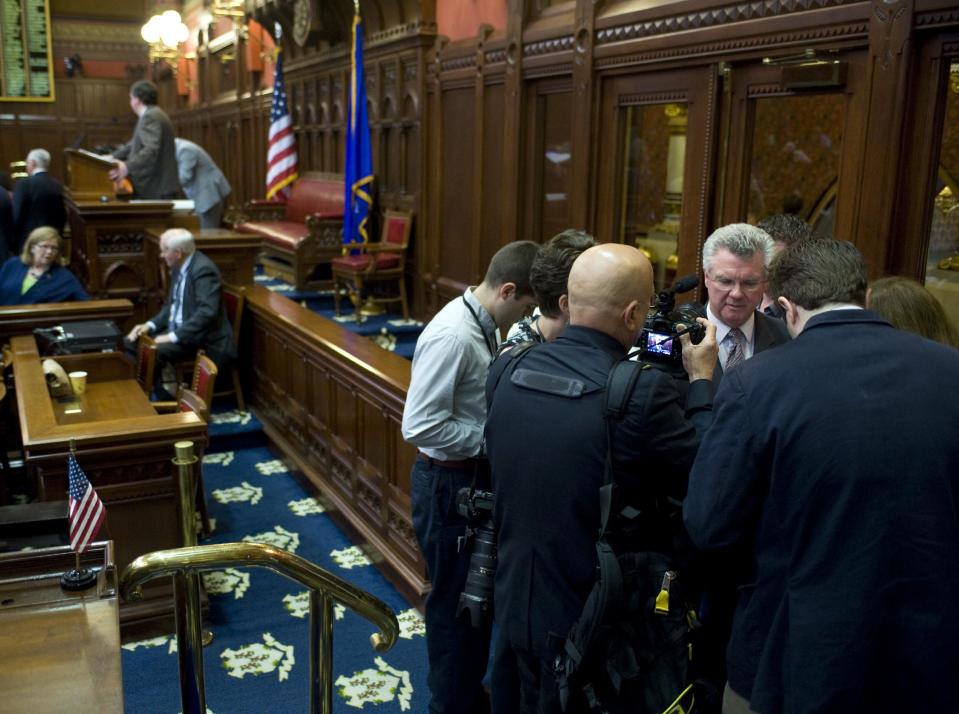 Connecticut House Speaker and Democratic candidate for U.S. Congress, Chris Donovan, right, stands away from the Speaker's podium as he speaks with reporters during special session at the Capitol in Hartford, Conn., Tuesday, June 12, 2012. Donovan opened the special legislative session but says he won't preside over the debate. Donovan, whose congressional campaign is under federal scrutiny, appeared at the podium Tuesday and presided over the opening prayer and Pledge of Allegiance but he then stepped aside and allowed a deputy House speaker to take over the deliberations. Robert Braddock Jr., Donovan's finance director was recently arrested by federal authorities and accused of conspiring to hide the source of $20,000 in campaign contributions. (AP Photo/Jessica Hill)