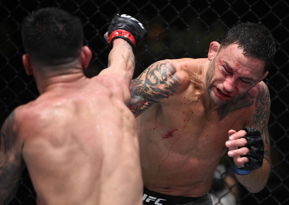 LAS VEGAS, NEVADA - AUGUST 22: (L-R) Pedro Munhoz of Brazil punches Frankie Edgar in their bantamweight fight during the UFC Fight Night event at UFC APEX on August 22, 2020 in Las Vegas, Nevada. (Photo by Chris Unger/Zuffa LLC)