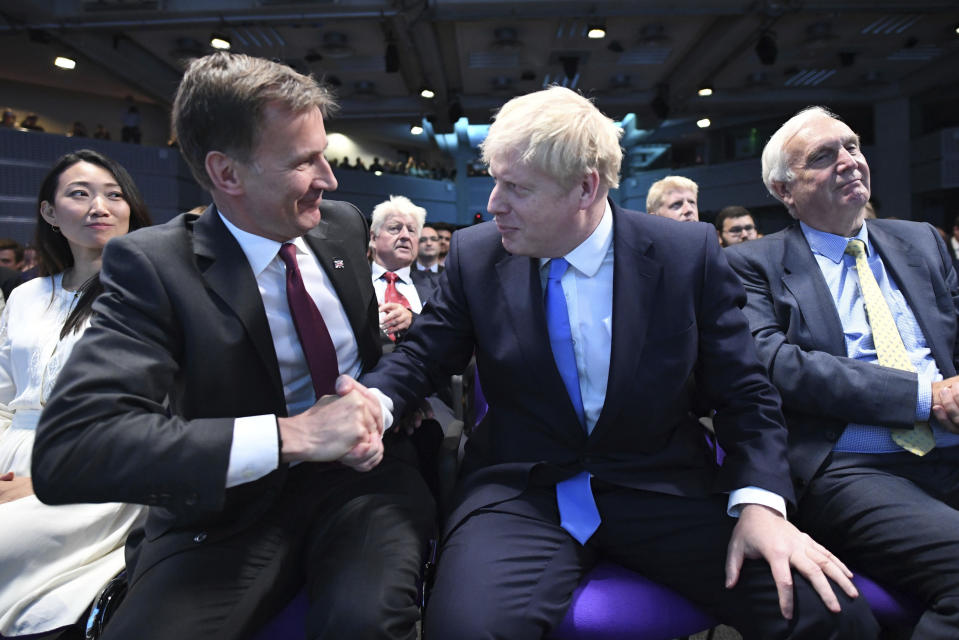 Jeremy Hunt, left, congratulates Boris Johnson after the announcement of the result in the ballot for the new Conservative party leader, in London, Tuesday, July 23, 2019. Brexit hardliner Boris Johnson won the contest to lead Britain's governing Conservative Party on Tuesday and will become the country's next prime minister, tasked with fulfilling his promise to lead the U.K. out of the European Union "come what may." (Stefan Rousseau/Pool photo via AP)