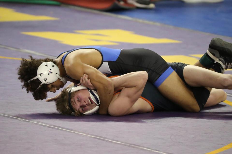 Kaiden Herendeen of Guthries, top, wrestles Jacob Caviness of Tahlequah Senior High School in the Class 5A 106-pound semifinal match during the Oklahoma state wrestling tournament at State Fair Arena in Oklahoma City, Friday, Feb. 24, 2023.