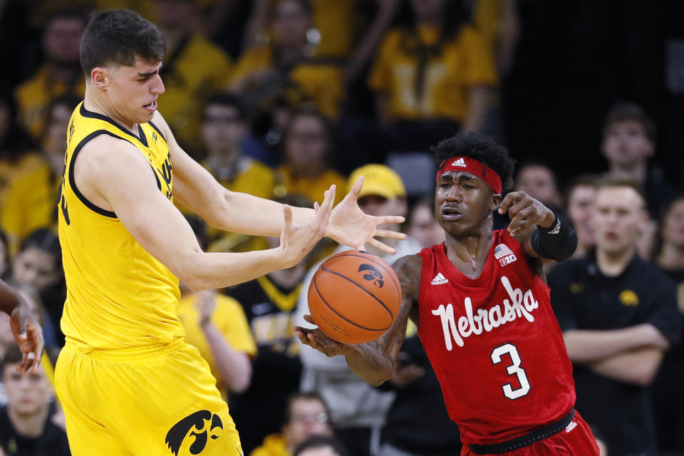 Nebraska guard Cam Mack (3) steals the ball from Iowa center Luka Garza during the first half of an NCAA college basketball game, Saturday, Feb. 8, 2020, in Iowa City, Iowa. (AP Photo/Charlie Neibergall)