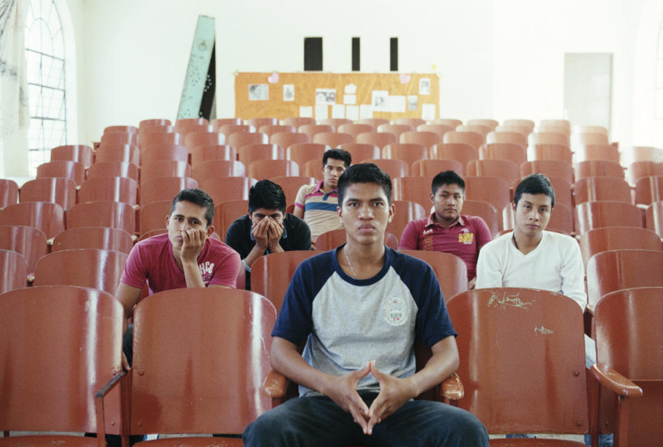 Student survivors of the Iguala attacks and disappearances sit in the auditorium of the Ayotzinapa Normal School on March 16, 2015.