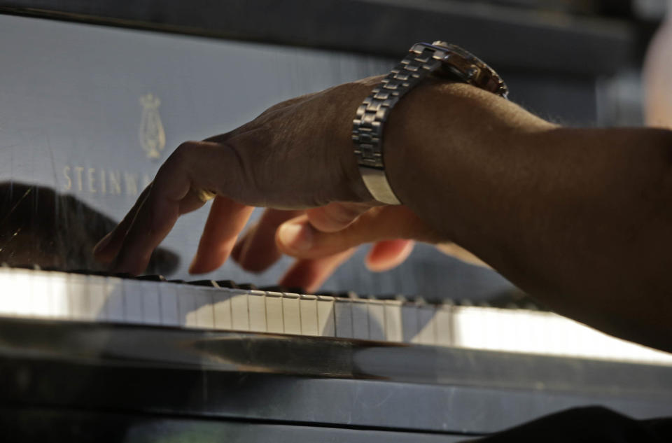 Ellis Marsalis, father and musical teacher of his sons, artists Wynton Marsalis, Branford Marsalis, Jason Marsalis and Delfeayo Marsalis, performs at the New Orleans Jazz and Heritage Festival in New Orleans, Saturday, May 3, 2014. (AP Photo/Gerald Herbert)