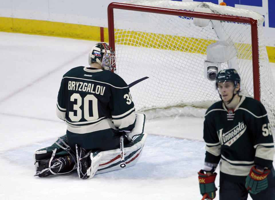 Minnesota Wild goalie Ilya Bryzgalov (30), of Russia, kneels in front of the net after Chicago Blackhawks right wing Patrick Kane scored the game-winning goal on him during overtime of Game 6 of an NHL hockey second-round playoff series in St. Paul, Minn., Tuesday, May 13, 2014. The Blackhawks won 2-1. (AP Photo/Ann Heisenfelt)