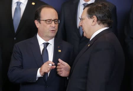 France's President Francois Hollande (L) talks with outgoing president Jose Manuel Barroso as they pose for a family photo during an EU summit in Brussels October 23, 2014. REUTERS/Christian Hartmann