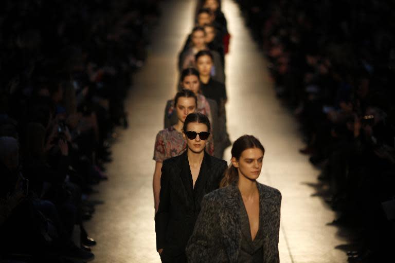 Models present creations from designer Paul Smith during London Fashion Week on February 16, 2014