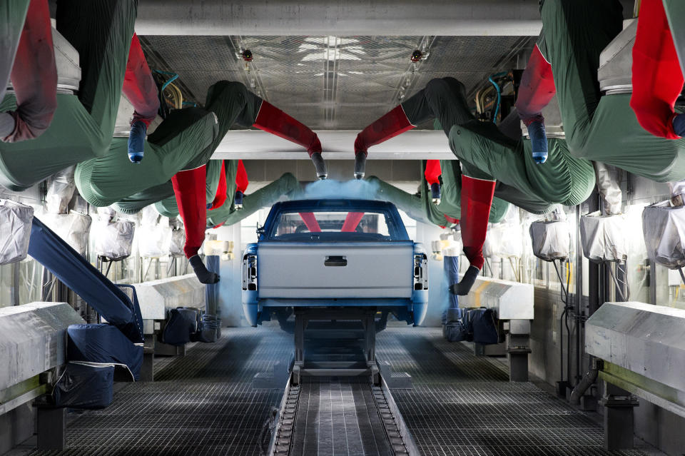 Machinery sprays paint on a pickup truck at GM&rsquo;s assembly facility in Flint, March 23.&nbsp;The base coat is applied by 18 robots. (Photo: Rachel Woolf for HuffPost)