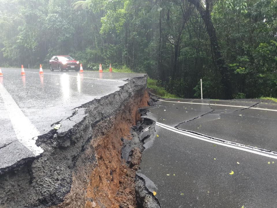 A road split in half along the Palmerston Highway in far north Queensland following heavy rain.