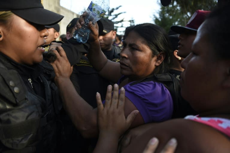 Relatives confront police outside a children's shelter in San Jose Pinula, east of Guatemala City, where 22 teenage girls died in a fire