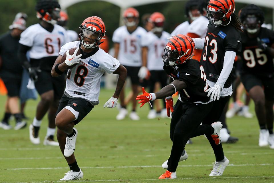 Cincinnati Bengals receiver Kwamie Lassiter II (18) runs with a catch during the first day of preseason training camp at the Paul Brown Stadium training facility in downtown Cincinnati on Wednesday, July 27, 2022.