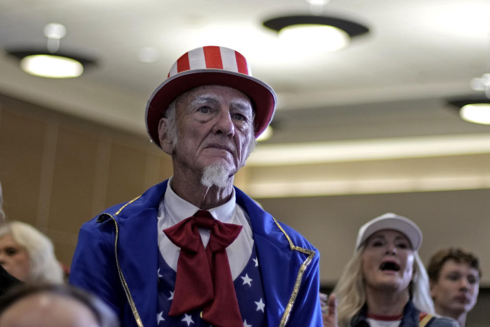 People listen as former President Donald Trump speaks during a rally, Friday, July 7, 2023, in Council Bluffs, Iowa. (AP Photo/Charlie Riedel)