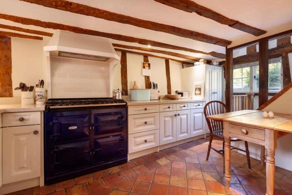Stoke By Clare, England October 17 2019: Kitchen interior inside traditional english cottage with exposed brickwork and beams, built in cuboards and o