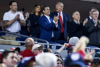 President Donald Trump, third from right, accompanied by first lady Melania Trump, second from left, and Republican lawmakers, reacts as the stadium boos when he is shown on the jumbo screen during a Salute to the Military during Game 5 of a baseball World Series game between the Houston Astros and the Washington Nationals at Nationals Park in Washington, Sunday, Oct. 27, 2019. Also Pictured are Rep. John Ratcliffe, R-Texas, center, and Rep. Mark Meadows, R-N.C., right. (AP Photo/Andrew Harnik)