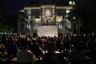 An audience attends a performance in the courtyard of the Sursock Museum, which was damaged in the explosion last August at Beirut's port, in Beirut, Lebanon, Thursday, July 8, 2021. Lebanon's only modern art museum, the Sursock, is still rebuilding a year after the explosion decimated it and some hope that reopening it will be a first step in the harder task of rebuilding the city's once thriving arts scene. (AP Photo/Hussein Malla)