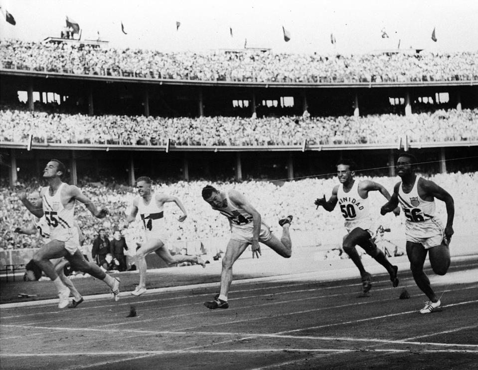 FILE - In this Nov. 23, 1956, file photo, United States' Bobby Joe Morrow (55) crosses the finish line of the men's 100-meter race in 10.5 seconds, equaling an Olympic record, during the Summer Olympics in Melbourne, Australia. (AP Photo/File)