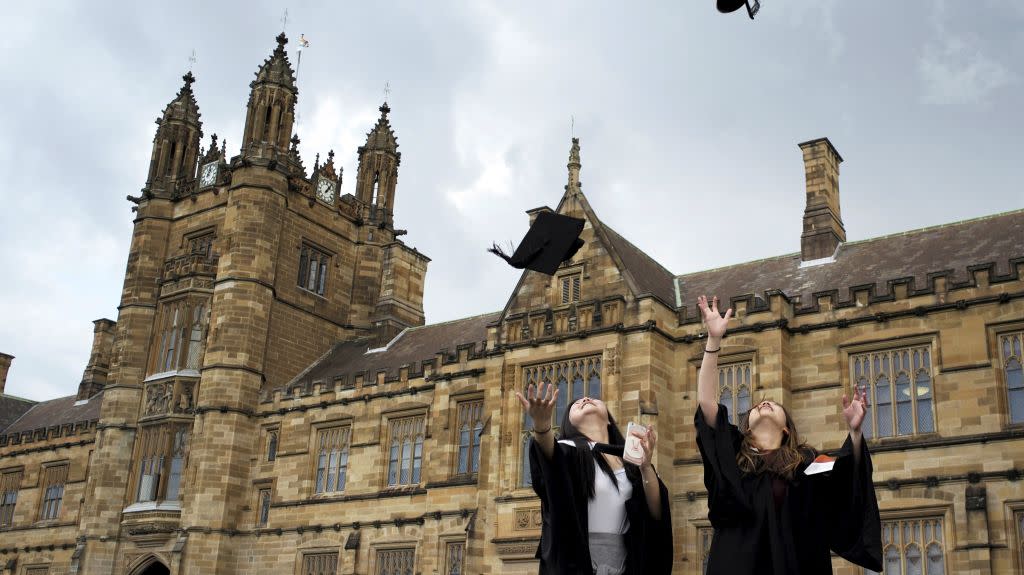 University students toss their graduation hats into the air for friends and family to take photos following their graduation ceremony at University of Sydney in Sydney, Australia, April 22, 2016.