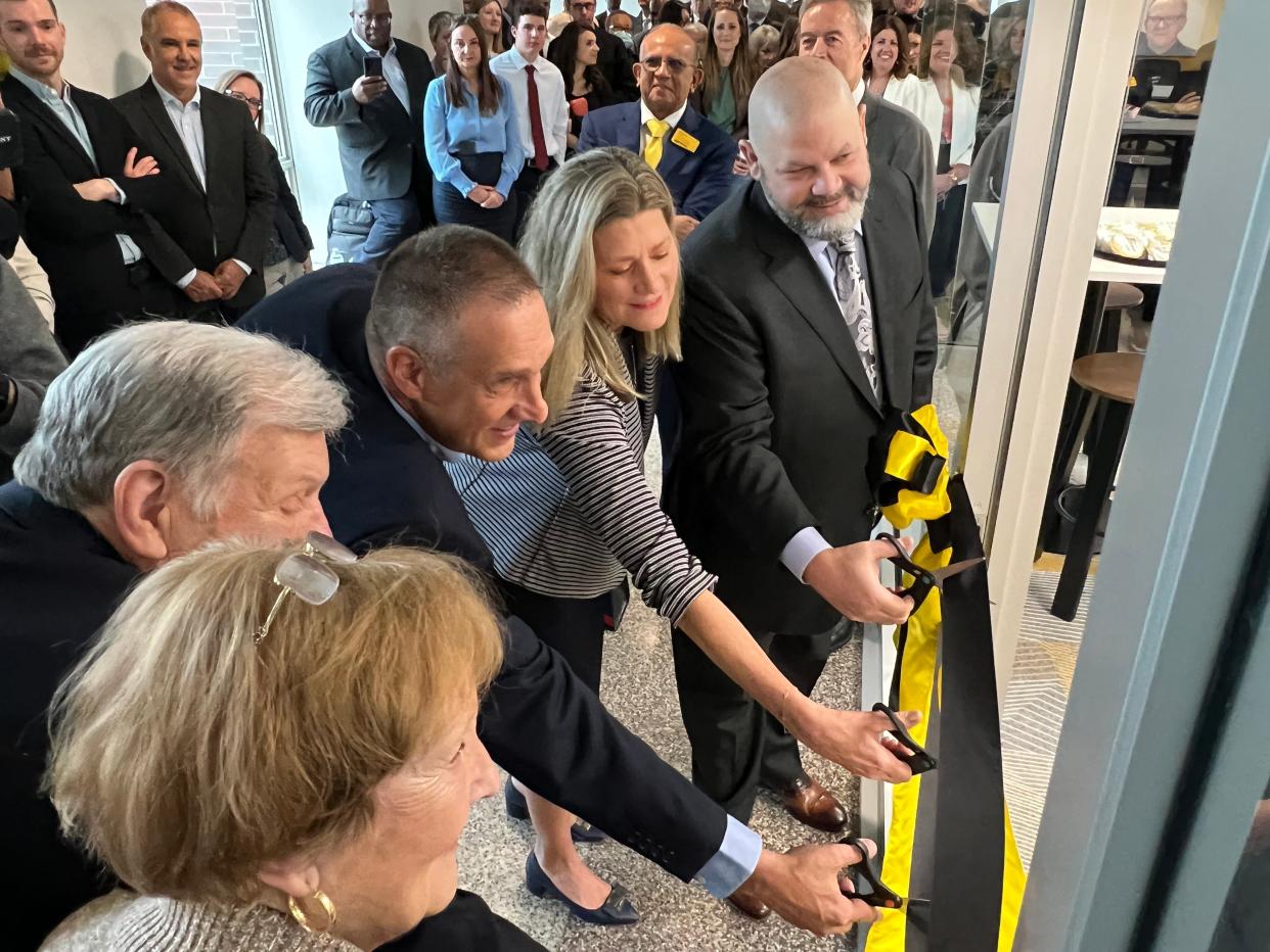 Several donors cut the ribbon symbolizing the opening of the Lubar Career Center at the University of Wisconsin-Milwaukee.