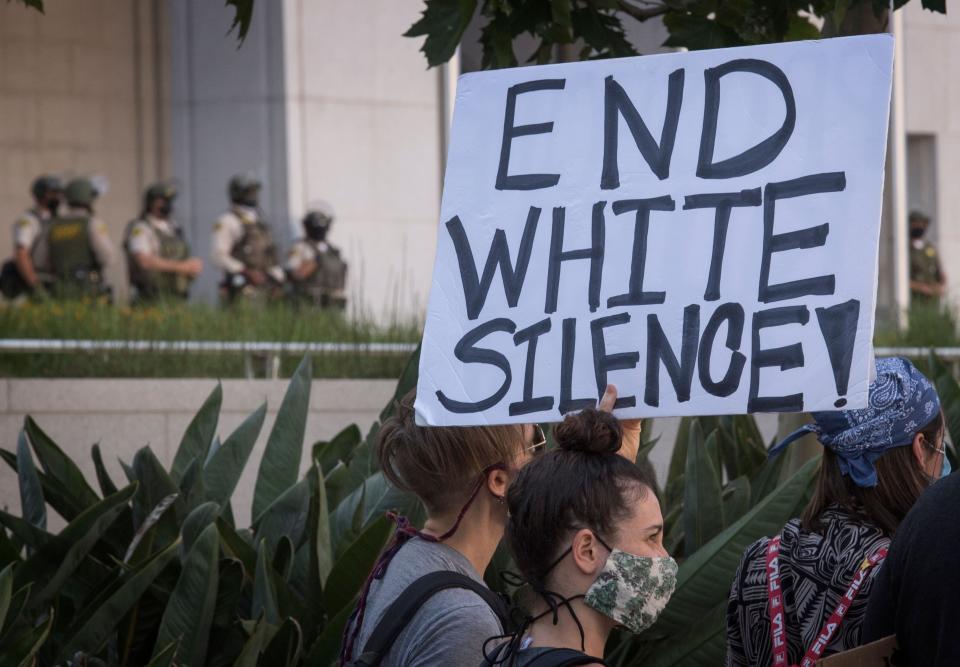 Supporters of Black Lives Matter, hold signs during a protest outside the Hall of Justice as they demonstrate against the death of George Floyd, in Los Angeles, California on June 10, 2020.   (Photo: MARK RALSTON via Getty Images)