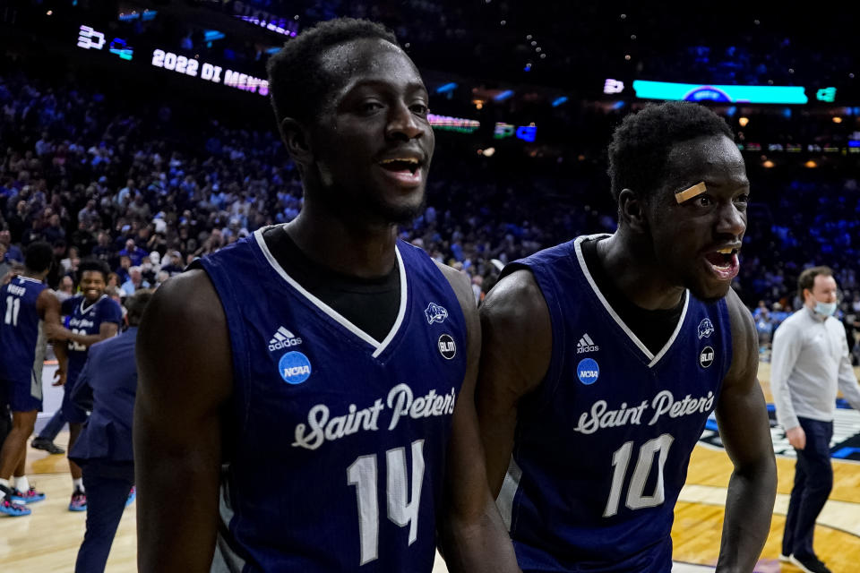 Saint Peter's Hassan Drame, left, and Fousseyni Drame, right, reacts to the win following the second half of a college basketball game against Purdue in the Sweet 16 round of the NCAA tournament, Friday, March 25, 2022, in Philadelphia. (AP Photo/Chris Szagola)