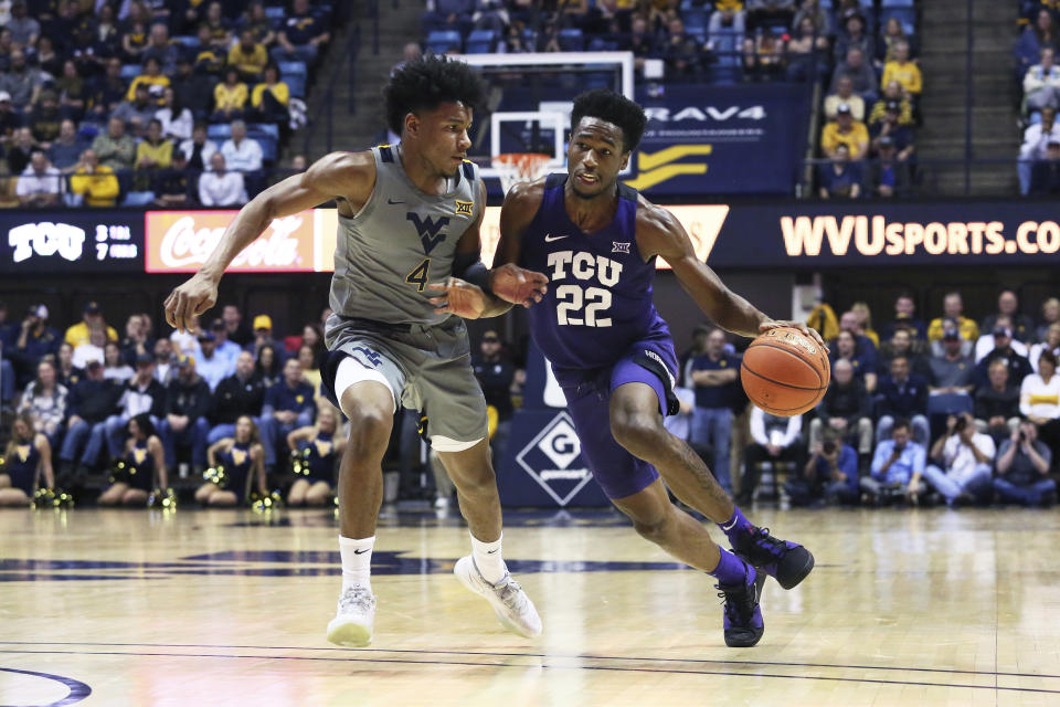 TCU guard RJ Nembhard (22) is defended by West Virginia guard Miles McBride during the first half of an NCAA college basketball game Tuesday, Jan. 14, 2020, in Morgantown, W.Va. (AP Photo/Kathleen Batten)