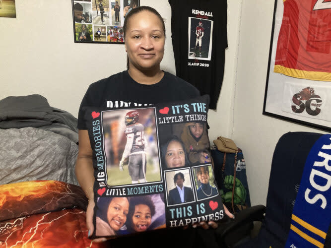 Shaketa Simmons holds a pillow emblazoned with images of her son, Kendall, who was killed Jan. 12, 2024 