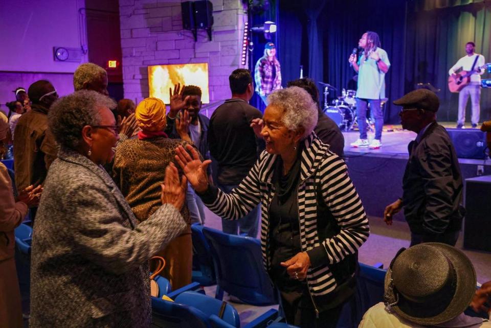 Members of Collab.Church greet one another during Sunday service on January 21, 2024, inside the auditorium of the North Dade Middle School in Miami Gardens, Florida Carl Juste/cjuste@miamiherald.com