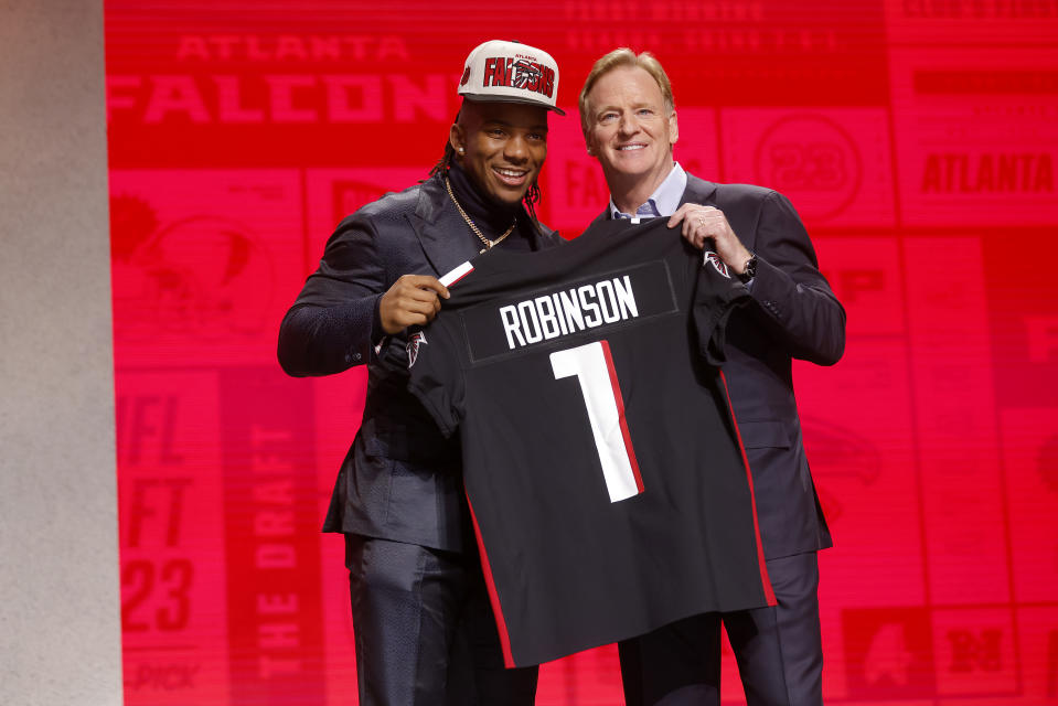 KANSAS CITY, MISSOURI - APRIL 27: (L-R) Bijan Robinson poses with NFL Commissioner Roger Goodell after being selected eight overall by the Atlanta Falcons during the first round of the 2023 NFL Draft at Union Station on April 27, 2023 in Kansas City, Missouri. (Photo by David Eulitt/Getty Images)