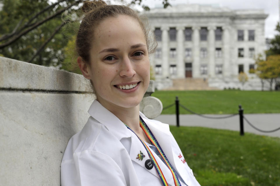 In this Thursday, Oct. 17, 2019 photo Harvard Medical School student Aliya Feroe, of Minneapolis, Minn., poses for a photograph on the school's campus, in Boston. Feroe recalls a flustered OB-GYN who referred her to another physician after learning she identified as queer. Medical schools are beefing up education on LBGTQ health issues. And some schools are making a big push to recruit LGBTQ medical students, backed by research showing that patients often get better care when treated by doctors who are more like them. (AP Photo/Steven Senne)