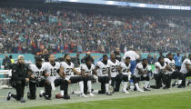 <p>New Orleans Saints players kneel down before the U.S. anthem was played for an NFL football game against the Miami Dolphins at Wembley Stadium in London, Sunday Oct. 1, 2017. (AP Photo/Matt Dunham) </p>