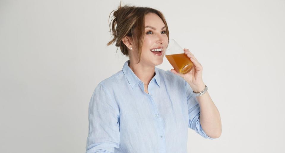 Woman drinking glass of DAYLY