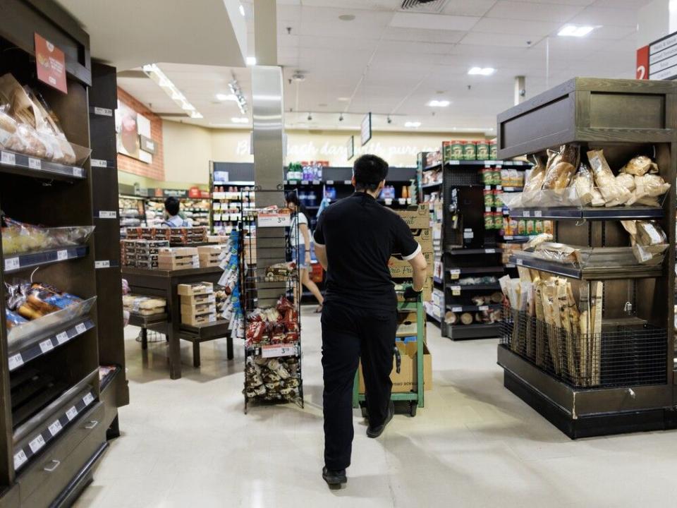  A worker inside a Metro grocery store in Toronto.