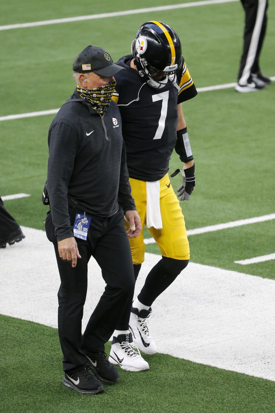 A member of the staff escorts Pittsburgh Steelers quarterback Ben Roethlisberger (7) to the locker room before the end of the first half of an NFL football game against the Dallas Cowboys in Arlington, Texas, Sunday, Nov. 8, 2020. (AP Photo/Michael Ainsworth)