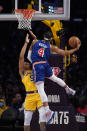 Golden State Warriors guard Moses Moody (4) shoots against Los Angeles Lakers guard Talen Horton-Tucker (5) during the first half of an NBA basketball game in Los Angeles, Saturday, March 5, 2022. (AP Photo/Ashley Landis)