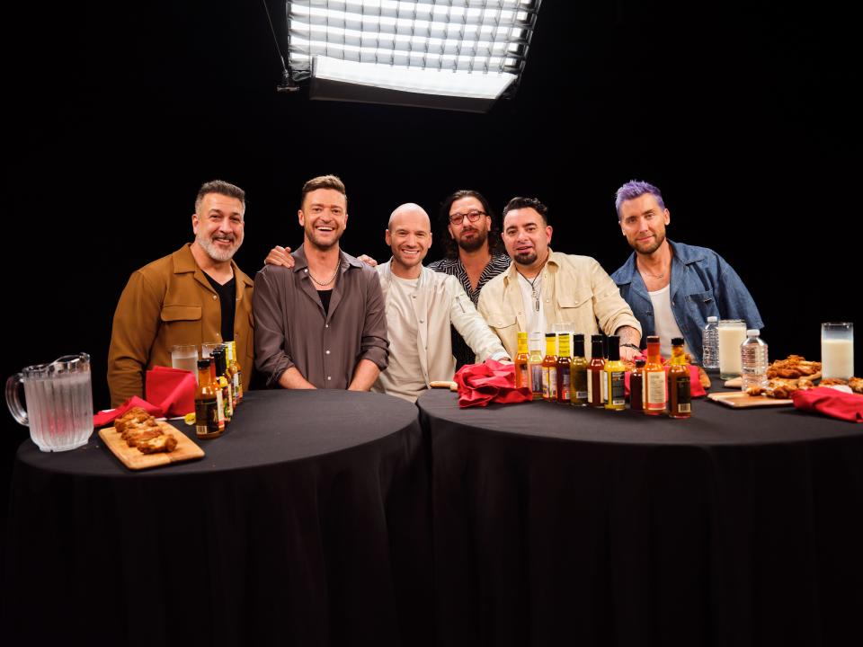 NSYNC members Joey Fatone (left), Justin Timberlake, JC Chasez, Chris Kirkpatrick and Lance Bass appear on the Sept. 21, 2023, episode of "Hot Ones" with host Sean Evans (center).
