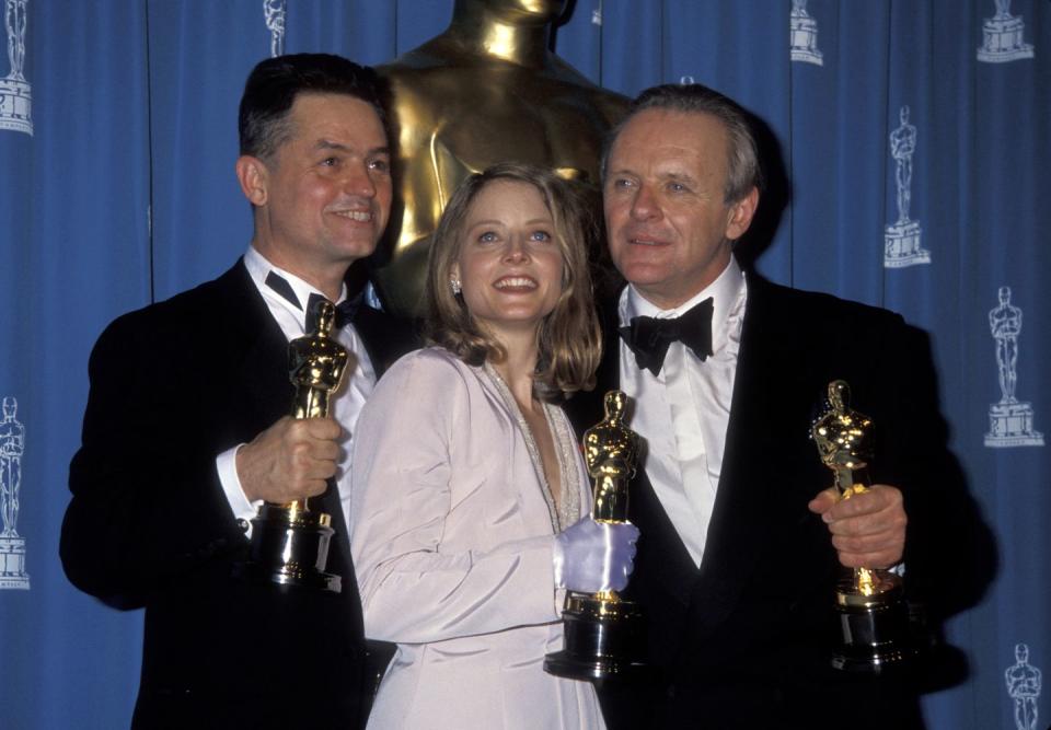 jodie foster, anthony hopkins, and jonathan demme holding their oscar trophies