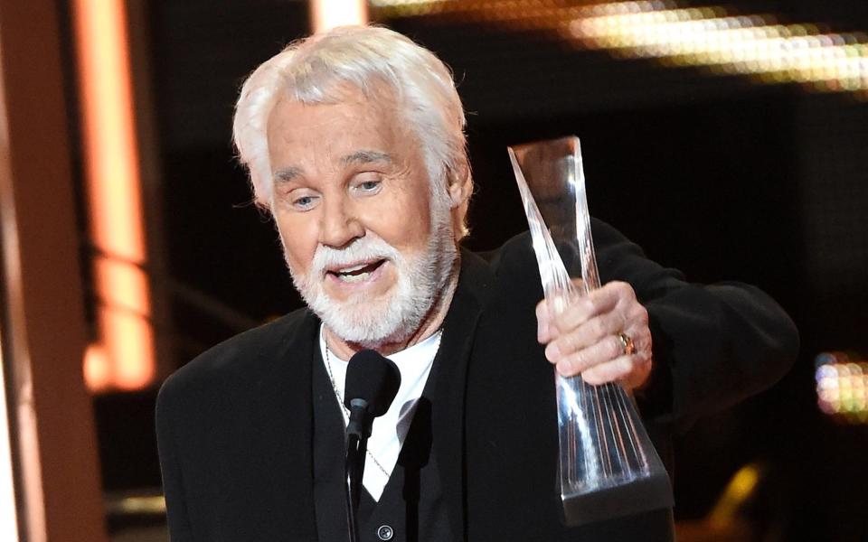 Kenny Rogers accepts his CMT lifetime achievement award in December 2015 - Getty Images