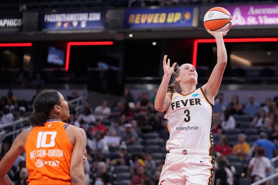 Indiana Fever's Kristy Wallace (3) shoots next to Connecticut Sun's Olivia Nelson-Ododa during the second half of a WNBA basketball game Friday, Aug. 4, 2023, in Indianapolis. (AP Photo/Darron Cummings)