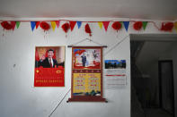 Posters showing images of Chinese President Xi Jinping and his wife Peng Liyuan are displayed on a wall of a home of members of the Yi minority group in Xujiashan village in Ganluo County, southwest China's Sichuan province on Sept. 10, 2020. Communist Party Xi’s smiling visage looks down from the walls of virtually every home inhabited by members of the Yi minority group in a remote corner of China’s Sichuan province. Xi has replaced former leader Mao Zedong for pride of place in new brick and concrete homes built to replace crumbling traditional structures in Sichuan’s Liangshan Yi Autonomous Prefecture, which his home to about 2 million members of the group. (AP Photo/Andy Wong)