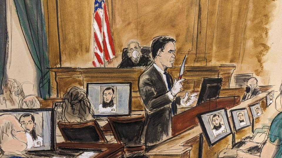 In this courtroom sketch, assistant US Attorney Jason Richmond gives the government summations in Manhattan federal court, Tuesday, Jan. 24, 2023, in New York, while holding up a knife that defendant Sayfullo Saipov possessed during his attack. Closing arguments were given in the trial where Saipov faces terrorism charges for killing eight people and seriously injuring a dozen others in an attack on a New York City bicycle path five years ago. (Elizabeth Williams via AP)