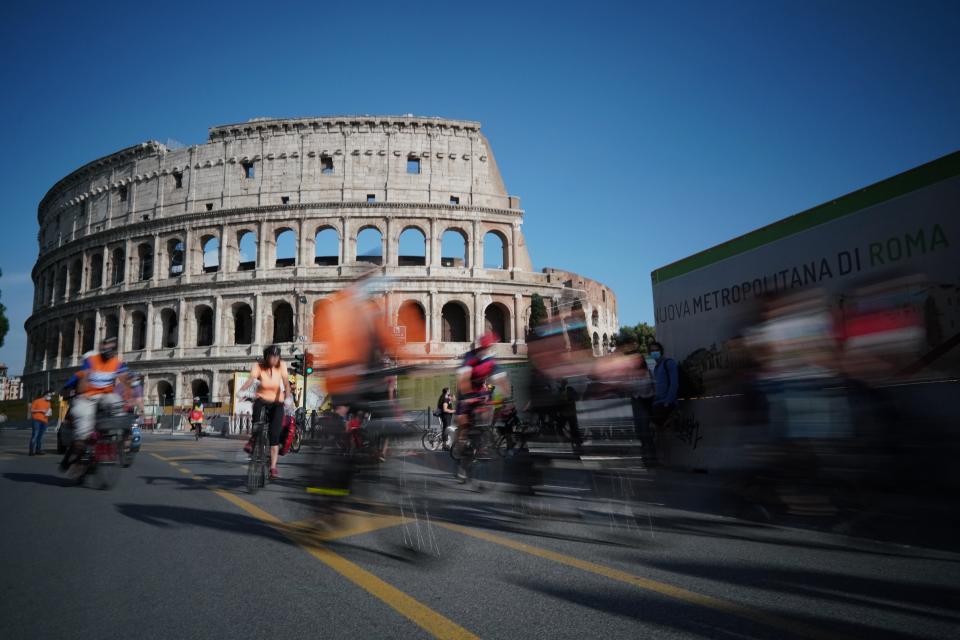 FILE - In this Friday, June 5, 2020 file photo, people cycle during a demonstration in front of the ancient Colosseum in Rome. The European Union on Wednesday, May 19, 2021 took a step toward relaxing tourism travel for visitors from outside the bloc, with EU ambassadors agreeing on measures to allow fully vaccinated visitors in. They also agreed on easing the criteria for nations to be considered a safe country, from which all tourists can travel. Up to now, that list included only seven nations. (AP Photo/Andrew Medichini, File)