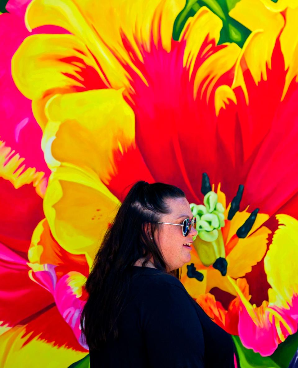 A person looks at some of the art on display by artist Sharon Sudduth on June 22, the opening day of the 2021 Festival of the Arts in Bicentennial Park in Oklahoma City.