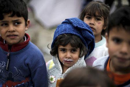 Refugee children are seen at a makeshift camp for refugees and migrants at the Greek-Macedonian border, near the village of Idomeni, Greece March 17, 2016. REUTERS/Alkis Konstantinidis