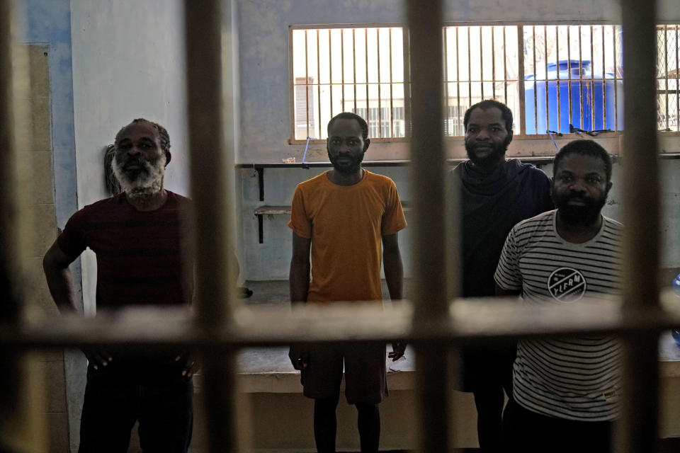 Detainees from Nigeria stand inside their cell at Tanjungpinang Central Immigration Detention Center on Bintan Island, Indonesia, Wednesday, May 15, 2024. This three-story detention facility, with its barred windows and fading paint, is home to dozens of detainees facing uncertain futures, including whether they will ever return to their homelands, in conditions that closely resemble a prison. (AP Photo/Dita Alangkara)