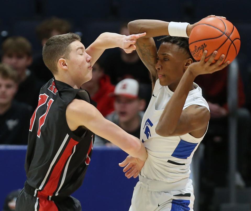 Richmond Heights guard Dorian Jones looks to make a pass around Hiland guard Sammy Detweiler in the first half of a 2022 Division IV state semifinal at UD Arena.