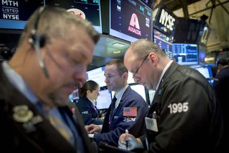 Traders work on the floor of the New York Stock Exchange January 29, 2015. REUTERS/Brendan McDermid